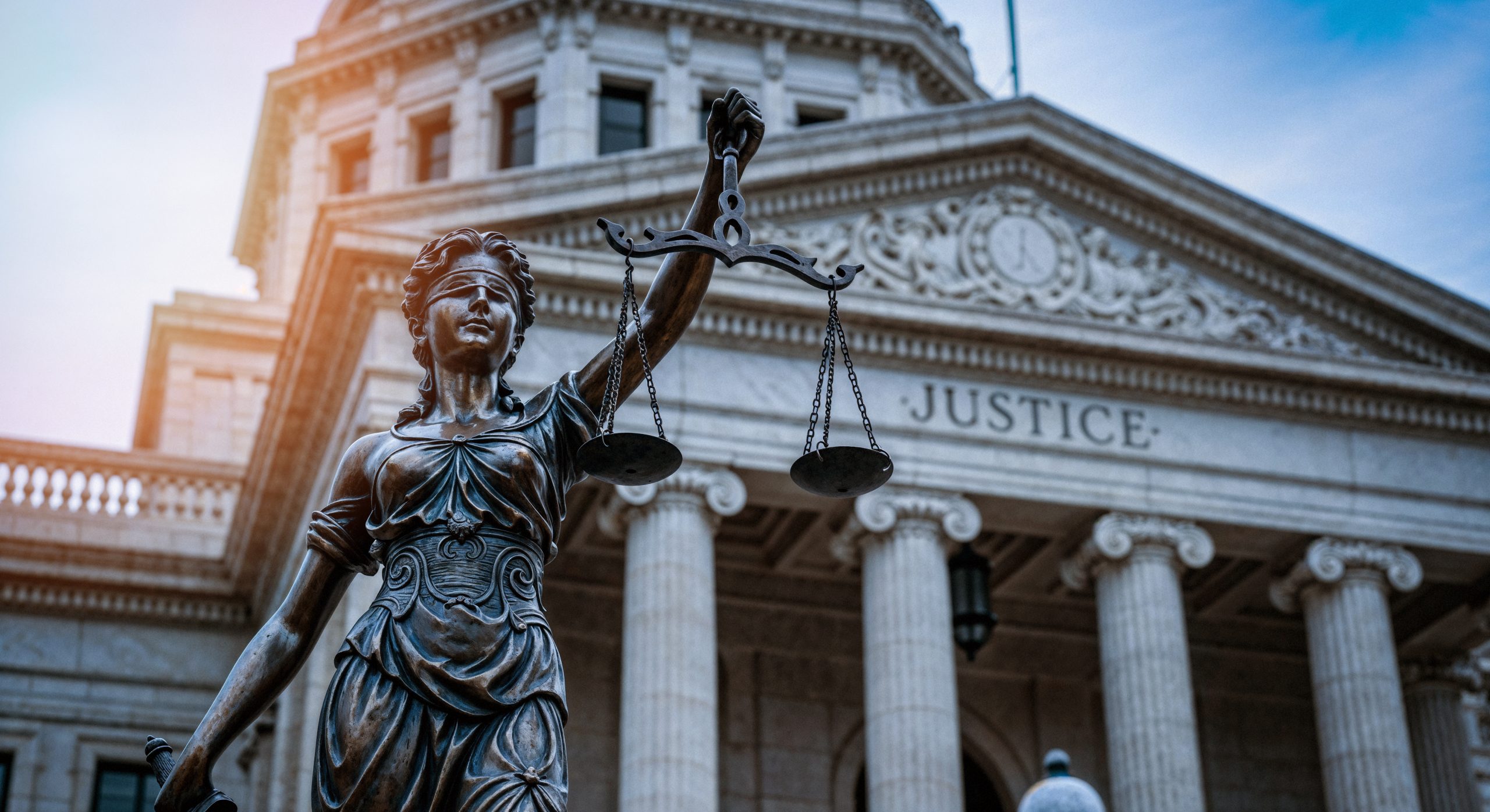 lady justice statue front courthouse